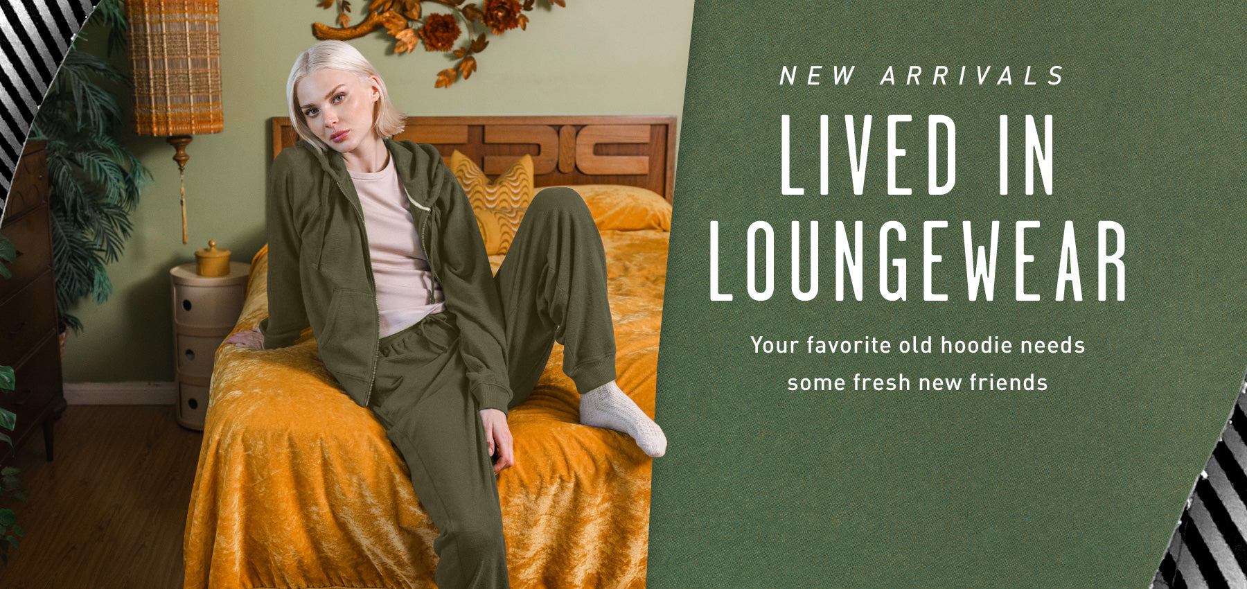 Person sitting on a bed wearing green loungewear with promotional text for 'Lived in Loungewear'.