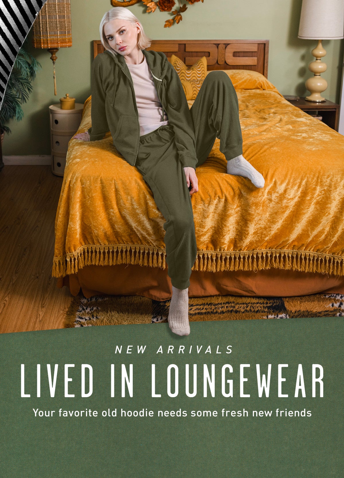 Person wearing green loungewear sitting on a bed with text 'Lived in Loungewear' at the bottom.
