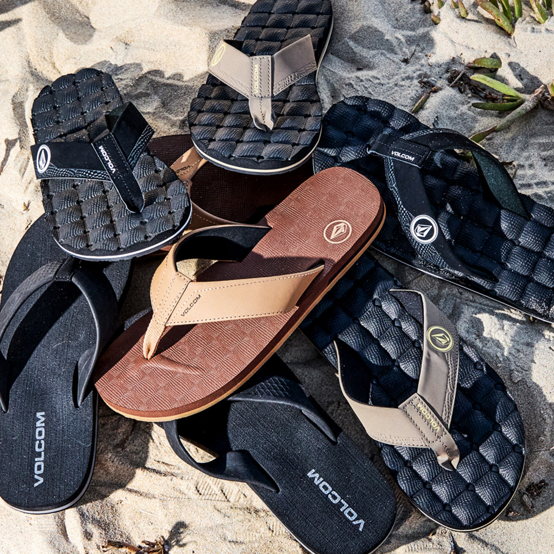 Collection of Volcom sandals on a textured surface