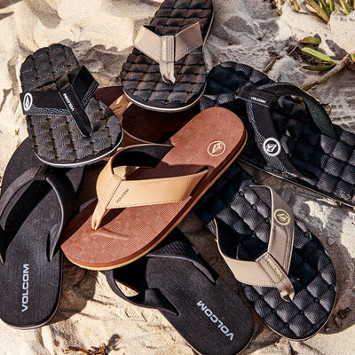 Collection of Volcom sandals on a textured surface