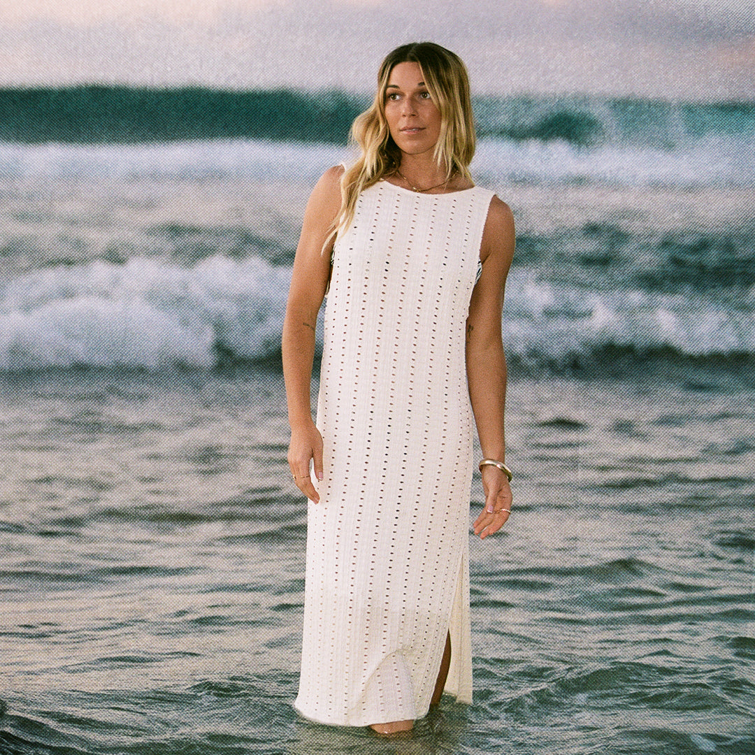 Woman in white dress standing in the ocean