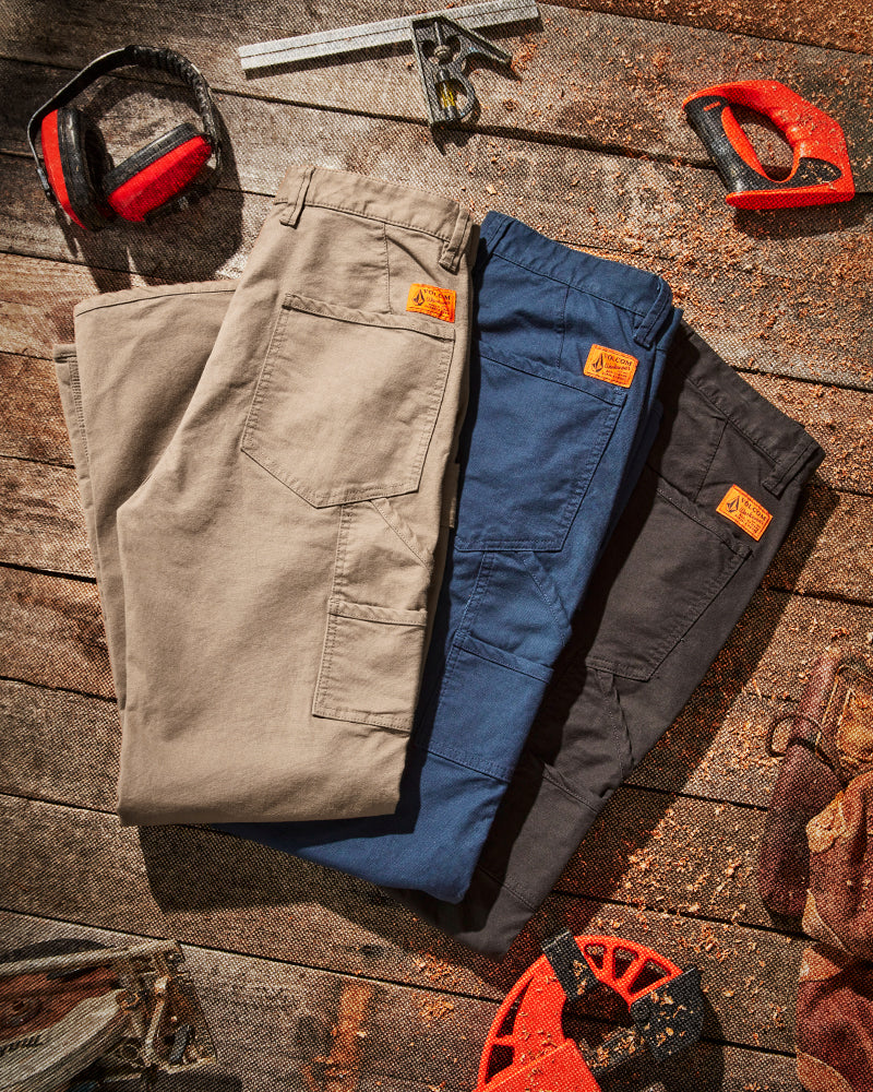 caliper pants flat lay with work tool around it. 