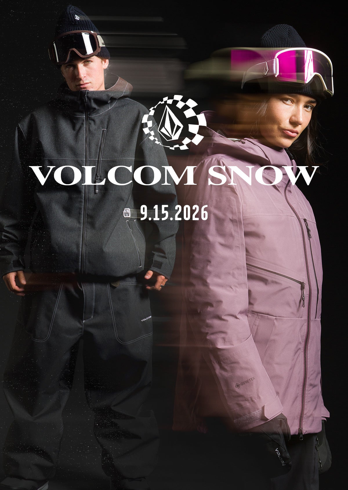 Two models wearing Volcom Snow apparel pose against a dark background. The model on the left wears a black ski jacket and pants with goggles, while the model on the right wears a dusty pink ski jacket and pants with pink-tinted goggles.