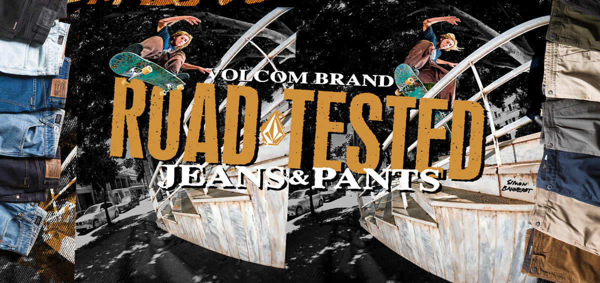 Volcom Brand 'Road Tested Jeans & Pants' graphic banner featuring skateboarder imagery, large tan 'ROAD TESTED' text, and side panels showing folded denim and pants in various colors.