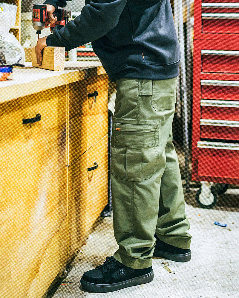 someone wearing workwear pants in a shop