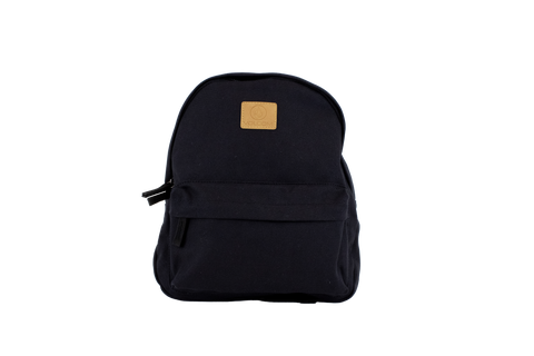 The Volcom Women's Winnie Backpack is a black mini backpack featuring a front zipper pocket and a tan square logo patch on the upper front, ideal for carrying your everyday essentials, shown against a plain white background.