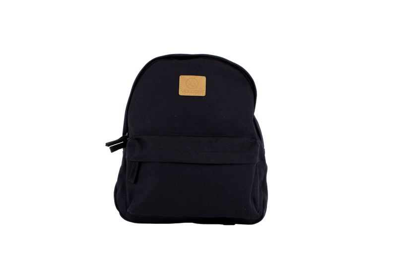 The Volcom Women's Winnie Backpack is a black mini backpack featuring a front zipper pocket and a tan square logo patch on the upper front, ideal for carrying your everyday essentials, shown against a plain white background.