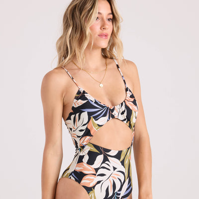 Woman wearing a floral one-piece swimsuit on a white background