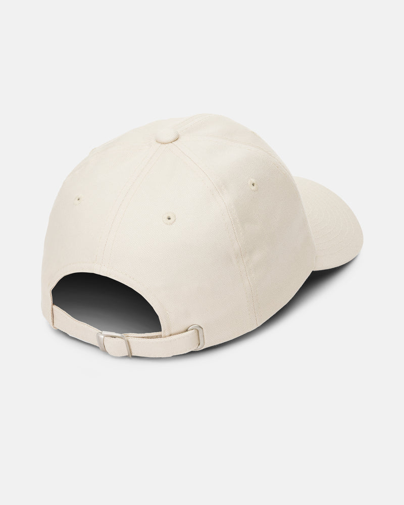 A rear view of the Women’s Stone Rising Hat by Volcom is shown, highlighting its beige color, 6-panel unstructured design, curved brim, stitched panels, and adjustable strap back with a metal buckle. This hat combines classic style with customizable comfort.