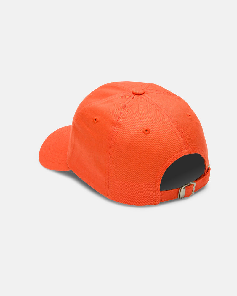 A Women's Circle Stone Dad Hat by Volcom in orange is shown from the back, highlighting its adjustable metal buckle strap. Crafted from 100% cotton and displayed on a plain white background.