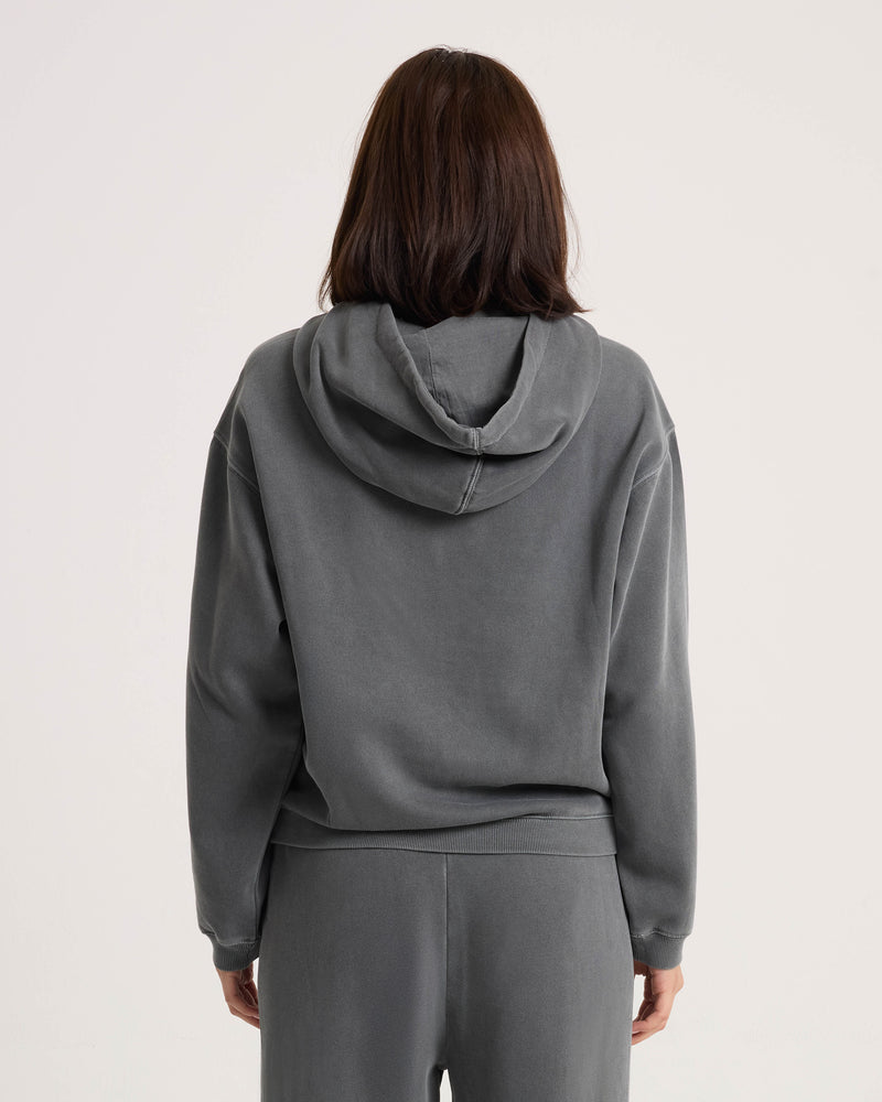 Rear view of a person wearing a vintage black plush fleece Women’s Stone Soft Hoodie and matching sweatpants.
