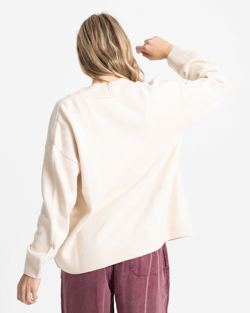 Rear view of a person wearing a cream-colored cotton-blend jacquard Women’s Sweater Weather Cardigan Jacquard.