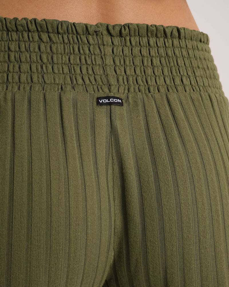 Close-up of the waistband and upper section of the Women’s Sun Lounge Short by Volcom, featuring a smocked elastic waist in Martini Olive and a small black Volcom logo tag at the center back.