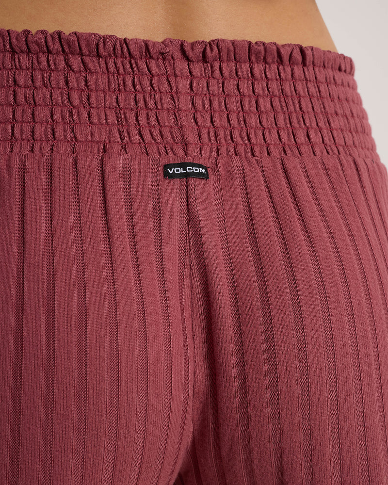 Volcom Women’s Sun Lounge Short in maroon, featuring ribbed fabric, a smocked waistband, and a small logo tag at the center back.