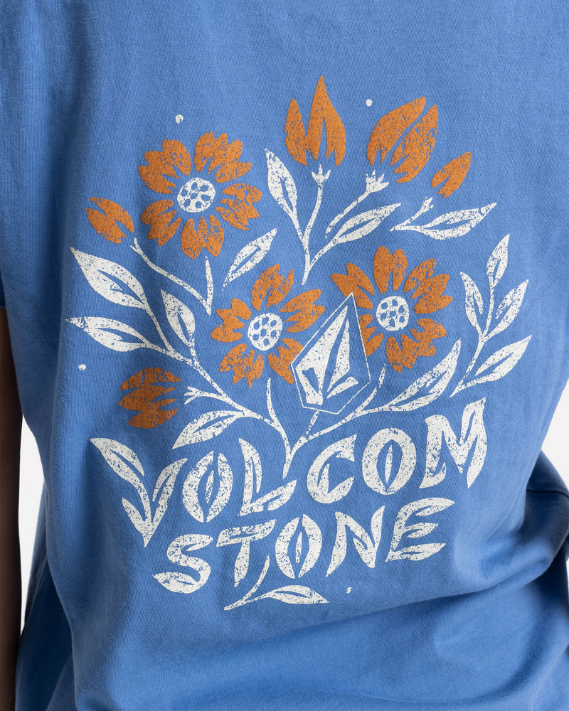 Volcom Women’s Fleur De Stone Lock It Up Tee: a blue boyfriend short sleeve t-shirt with a screen-printed graphic of orange and white flowers, a geometric diamond logo, and the text VOLCOM STONE.