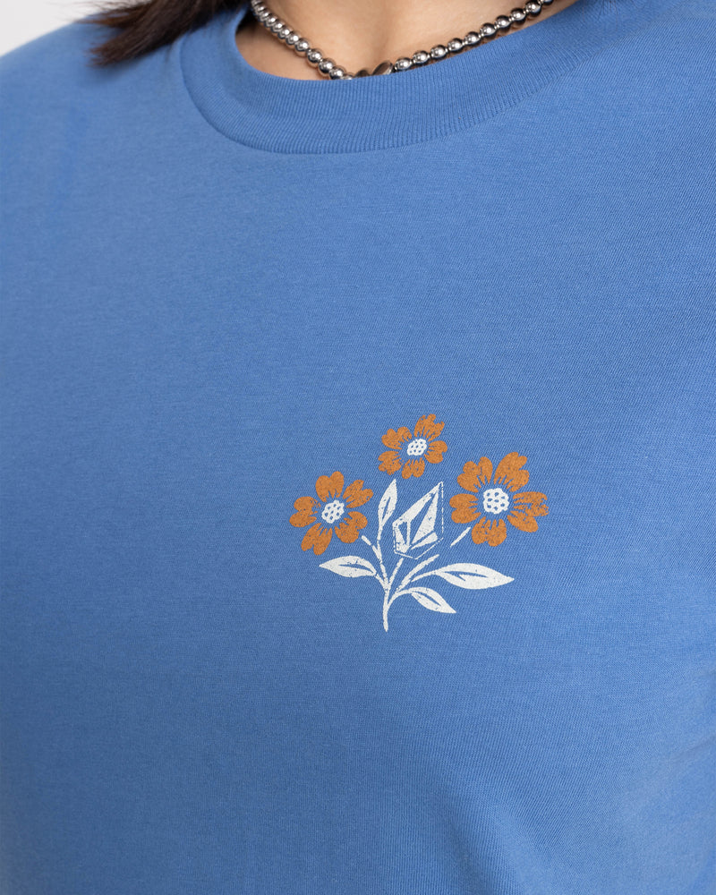 Volcom Women’s Fleur De Stone Lock It Up Tee in blue, a boxy boyfriend graphic tee featuring three orange flowers and a diamond-shaped stone on the left chest.