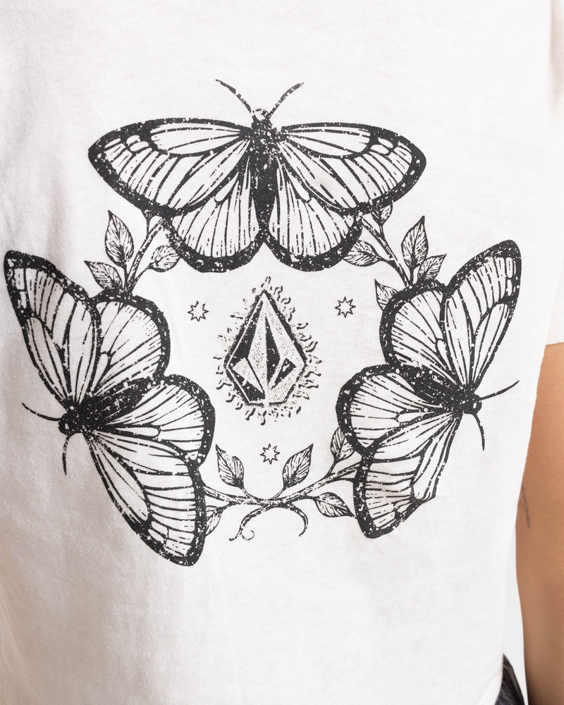 Black line art butterflies, leaves, stars, and a diamond shape decorate the back of the Women’s BuTeeTeeerfly Ring Pocket Dial Tee by Volcom, a 100% cotton boxy fit t-shirt.