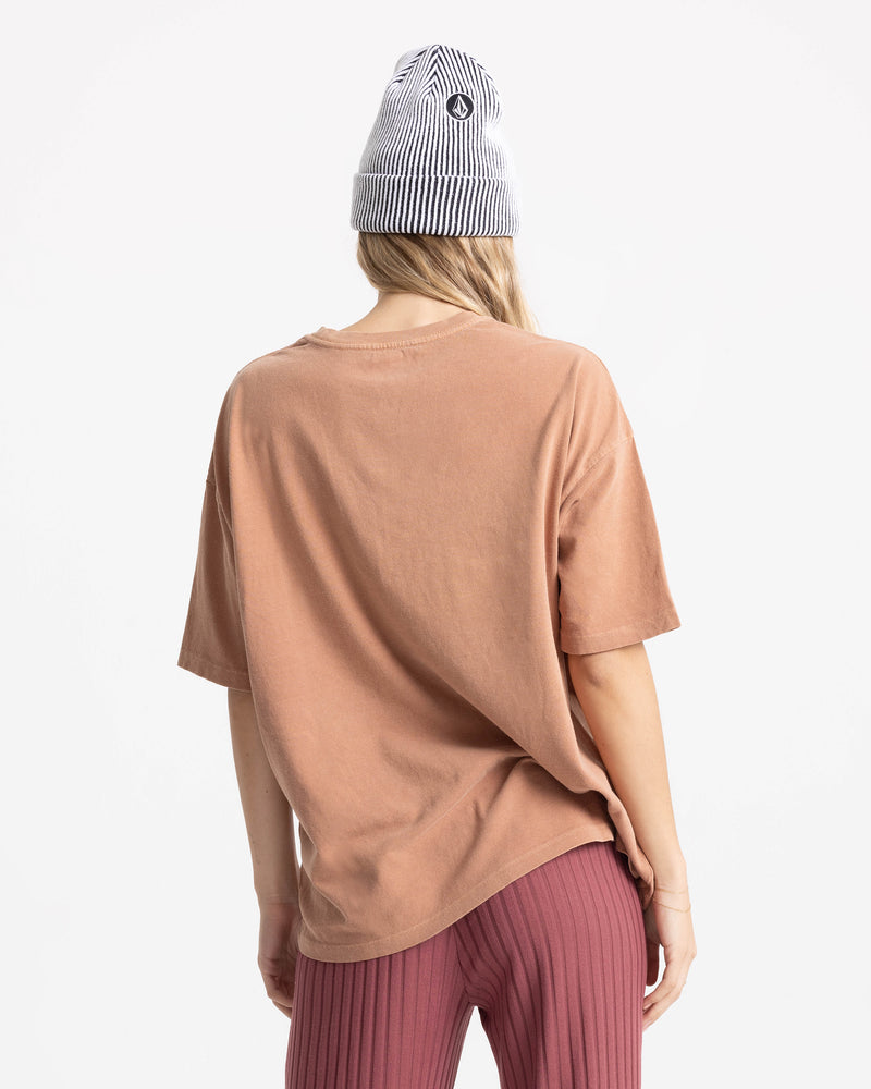 A person wearing the Women’s Mystic Palms Bad Tee by Volcom stands facing away from the camera against a white background.