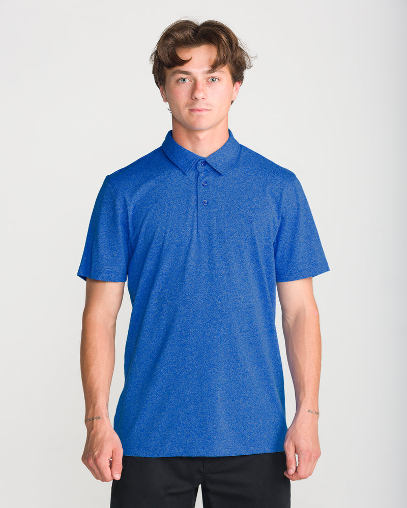 A man wearing a Nebulas Blue Men’s Wowzer Polo Short Sleeve by Volcom, featuring a button placket.