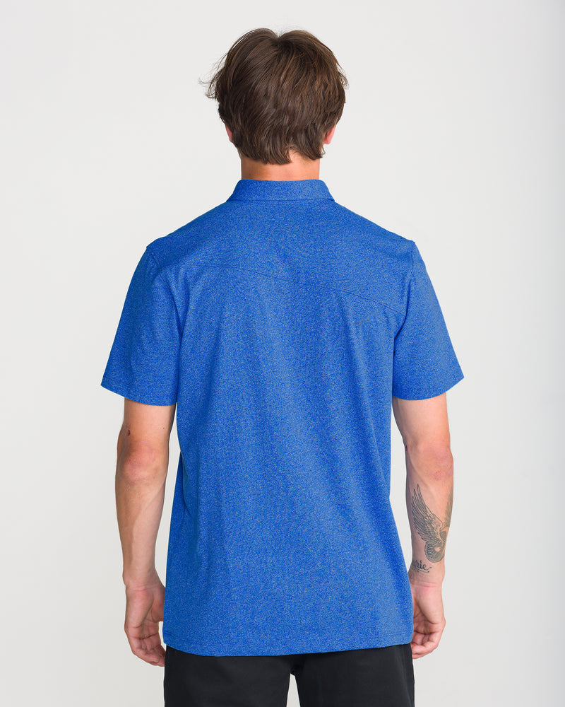 Back view of a person wearing a Nebulas Blue Men’s Wowzer Polo Short Sleeve and black shorts.
