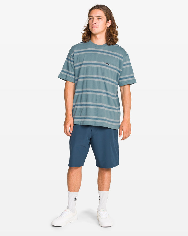 Man wearing a striped t-shirt and shorts on a white background