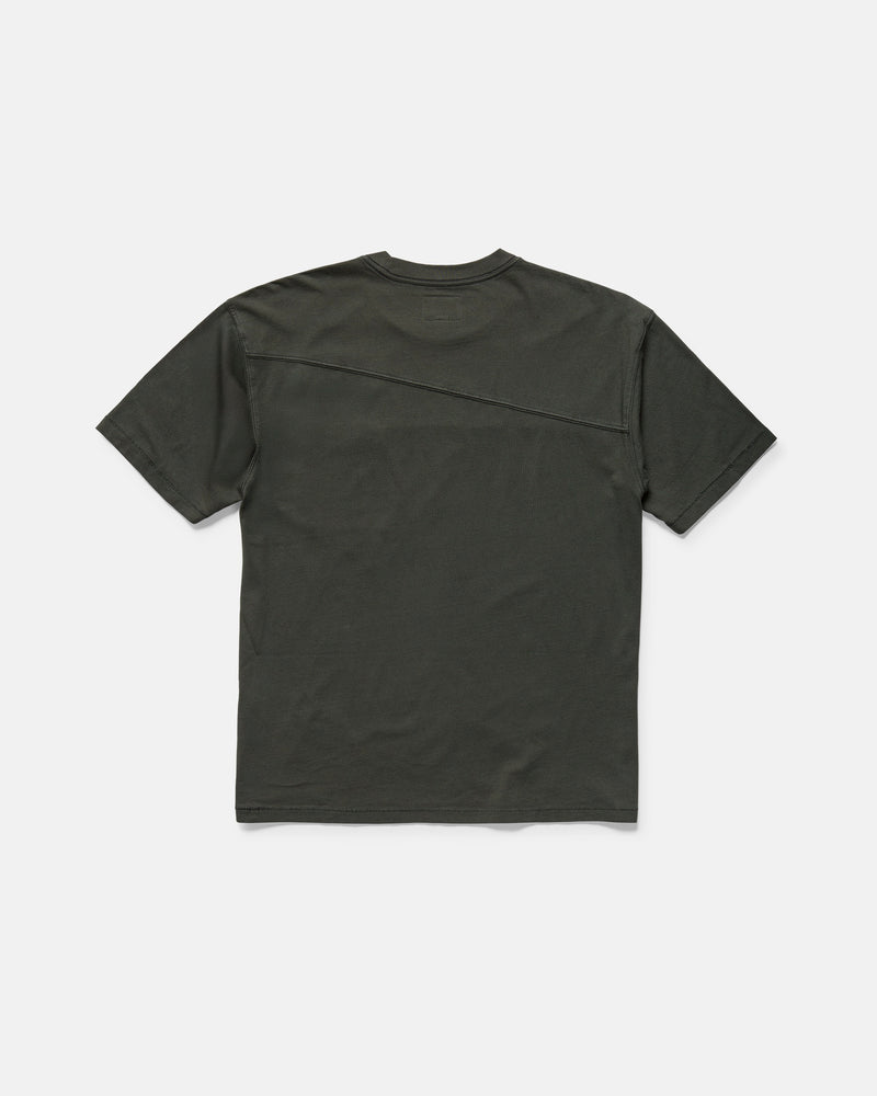 The Volcom Men's Stone Cruiser Crew is a plain, dark green short-sleeve t-shirt laid flat and viewed from the back. Made from 100% cotton jersey, it features a subtle diagonal seam from the right shoulder to the left side.