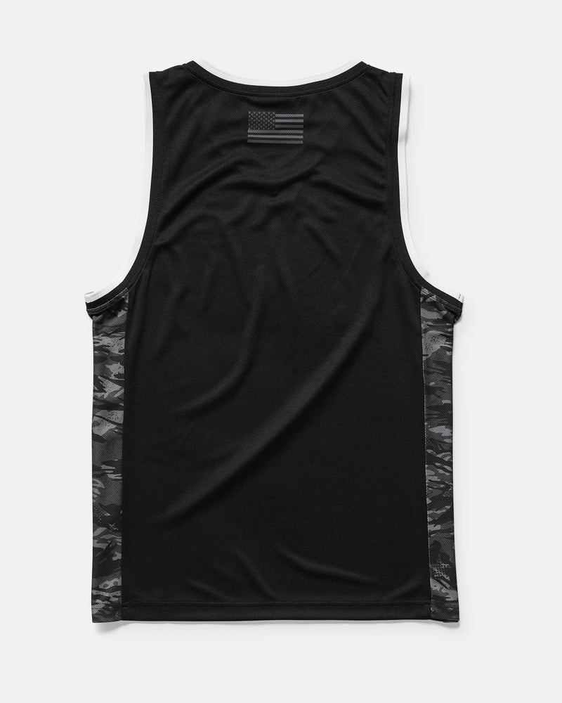 The Men's Froth Of July Tank by Volcom is shown from the back, featuring a small black-and-gray American flag at the upper back, dark camo side panels with closed-cell mesh, and white trim on the neckline and armholes.
