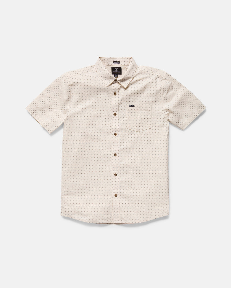 The Volcom Men's Bankstone II Short Sleeve Tee features a classic fit, beige color, subtle textured dobby dotted pattern, front chest pocket, and brown buttons, displayed laid flat on a white background.