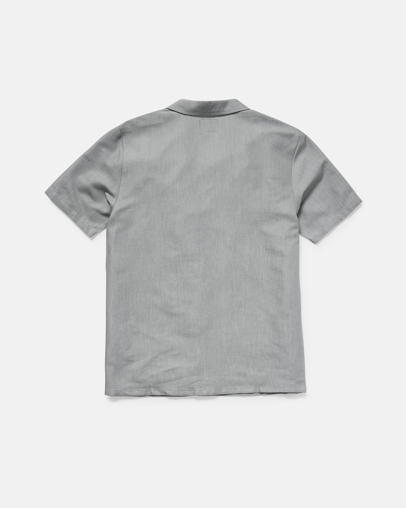The Men's Otis Stone Short Sleeve Tee by Volcom, featuring a boxy fit and light gray color, is displayed from the back on a plain white background.