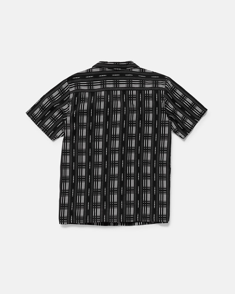 The Volcom Men's Macros Short Sleeve Tee is displayed flat with the back facing up. It features a boxy fit, black base, and white geometric grid pattern.