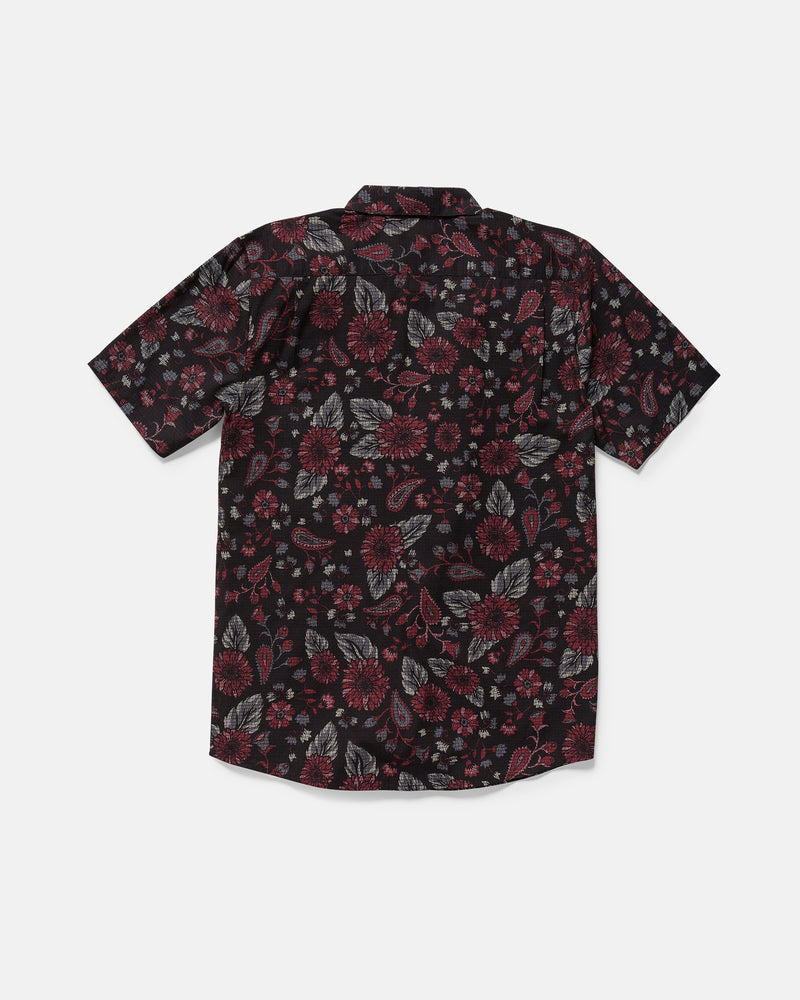 The Volcom Men's Scaler Stone Woven Short Sleeve Shirt features a black base with an all-over red, gray, and white floral pattern. This classic fit button-up is shown laid flat with the back side facing up.