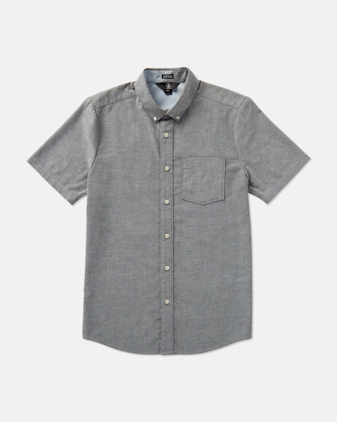 The Volcom Men's Everett Oxford Short Sleeve Tee in gray, with a slim fit, button-down collar, chest pocket, and subtle branding, is shown laid flat on a plain white background.