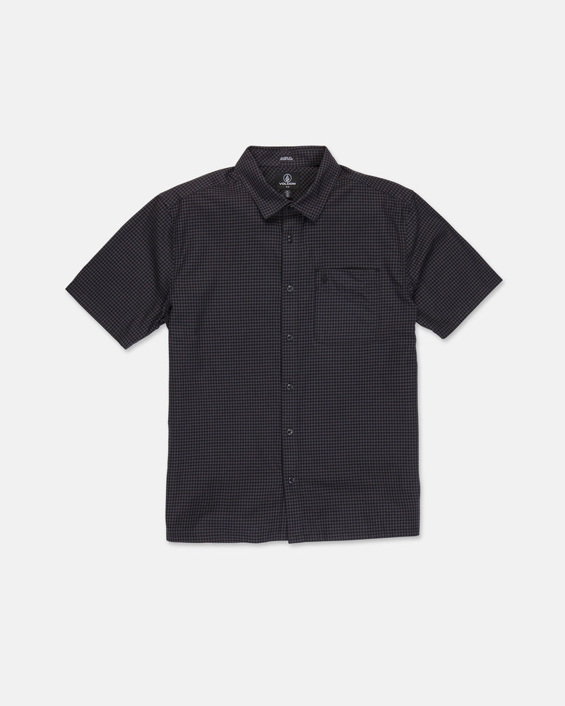 The Volcom Men's Glasnow Short Sleeve Shirt, shown laid flat on a white background, features a black cotton fabric with a subtle small yarn-dyed checkered pattern, button-up front, flat collar, and chest pocket.