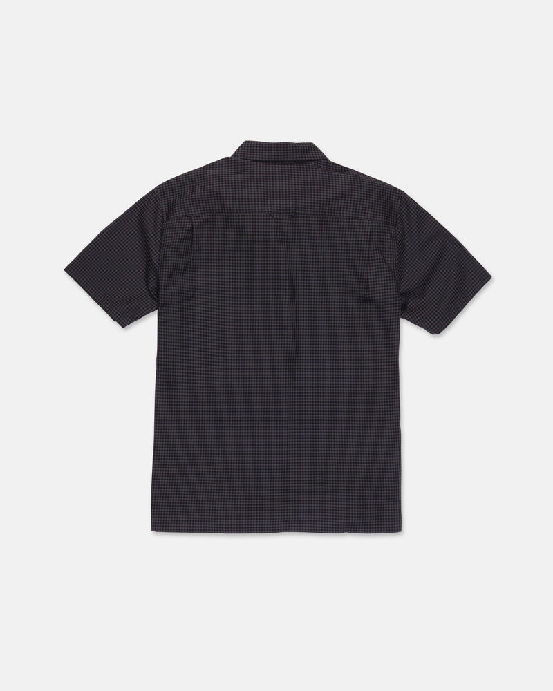 A Volcom Men's Glasnow Short Sleeve Shirt, featuring a small yarn-dyed checkered pattern in dark colors and made from cotton, is laid flat with the back side visible against a white background.