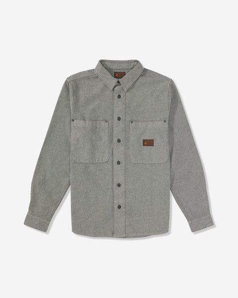The Men's Levelstone Long Sleeve Shirt is a gray button-up with two chest pockets, front buttons, and a small brown logo patch on the left pocket, displayed on a plain white background.