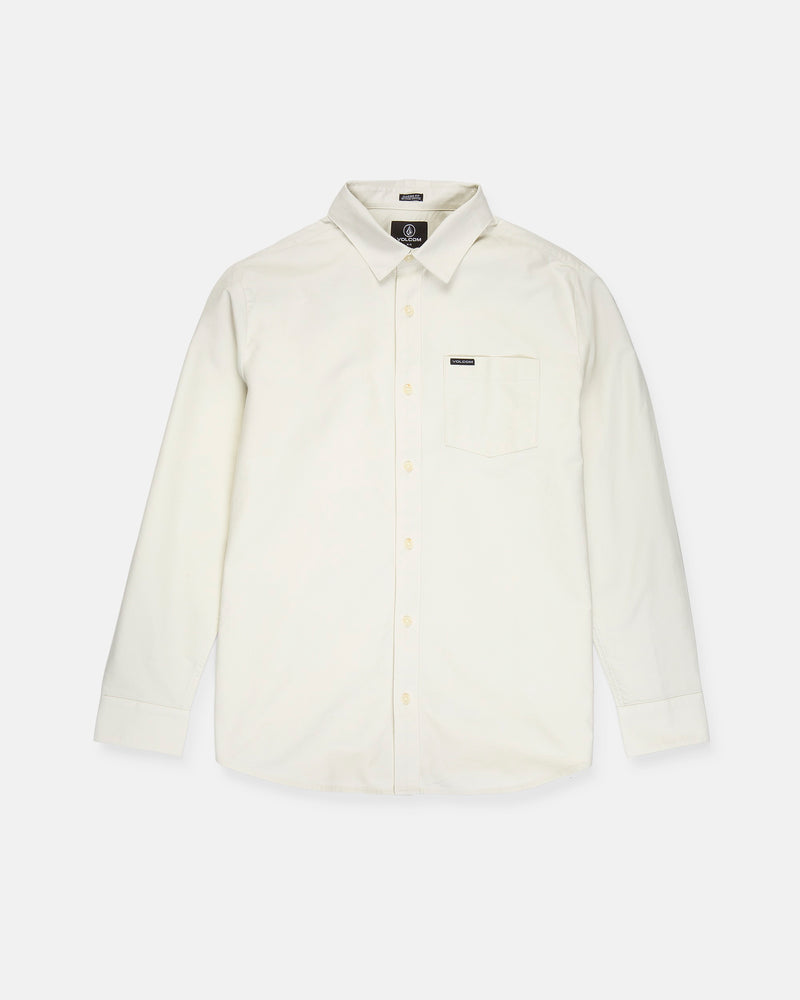 A Volcom Men's Veeco Oxford Long Sleeve Shirt in plain off-white, featuring a classic fit with a pointed collar and single chest pocket, is laid flat on a white background.