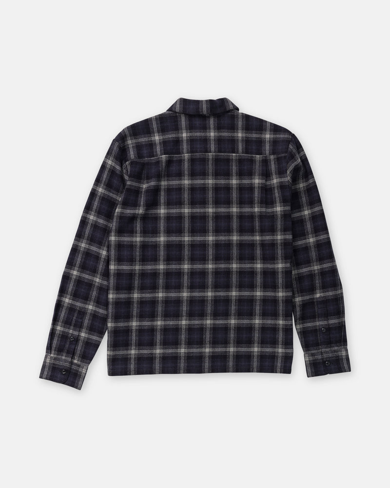 Back view of the Volcom Men’s Fieldstone Long Sleeve, a heavyweight, dark plaid flannel shirt in a modern boxy fit with long sleeves and a button-down design.