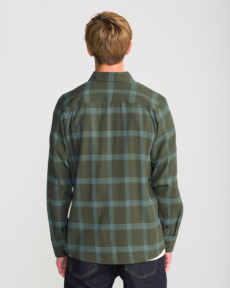 Back view of a person wearing a dark green plaid Men’s Netastone Long Sleeve flannel shirt and dark jeans.
