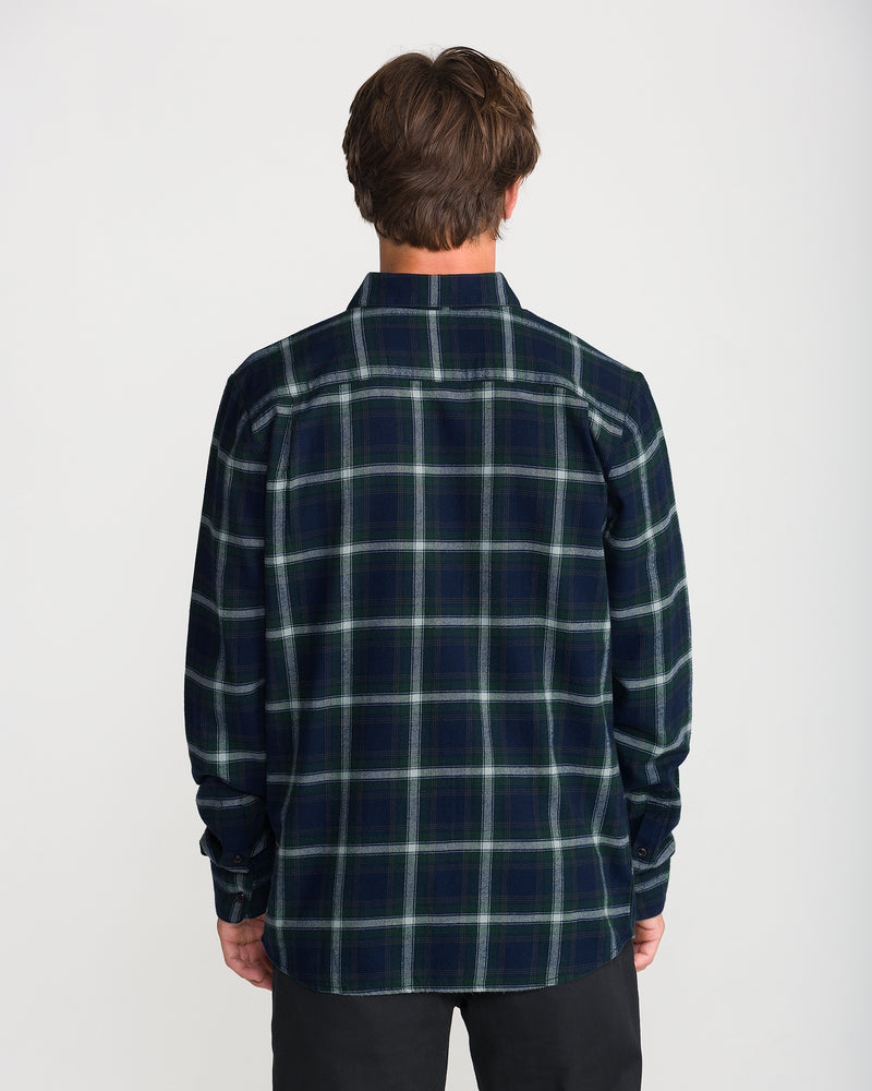 Back view of a person wearing a green and navy Men’s Caden Plaid Long Sleeve classic fit button-down shirt.