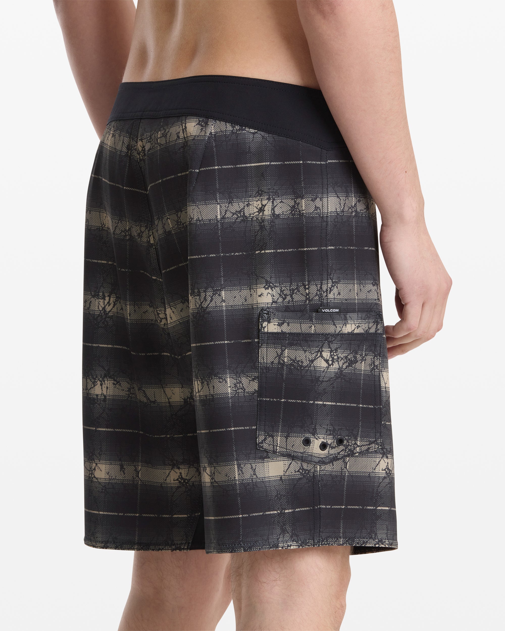 A man wearing Volcom's Men's Grunge Snap Mod 18 shorts.