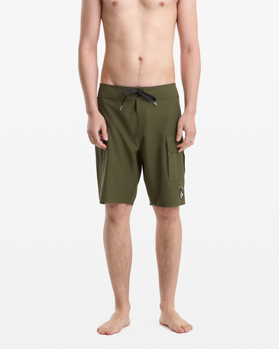 A shirtless, barefoot person faces forward against a white background, wearing Volcom Men's Hawaii Truly Preemo Mod 20 olive green board shorts with a drawstring waist and side pocket.