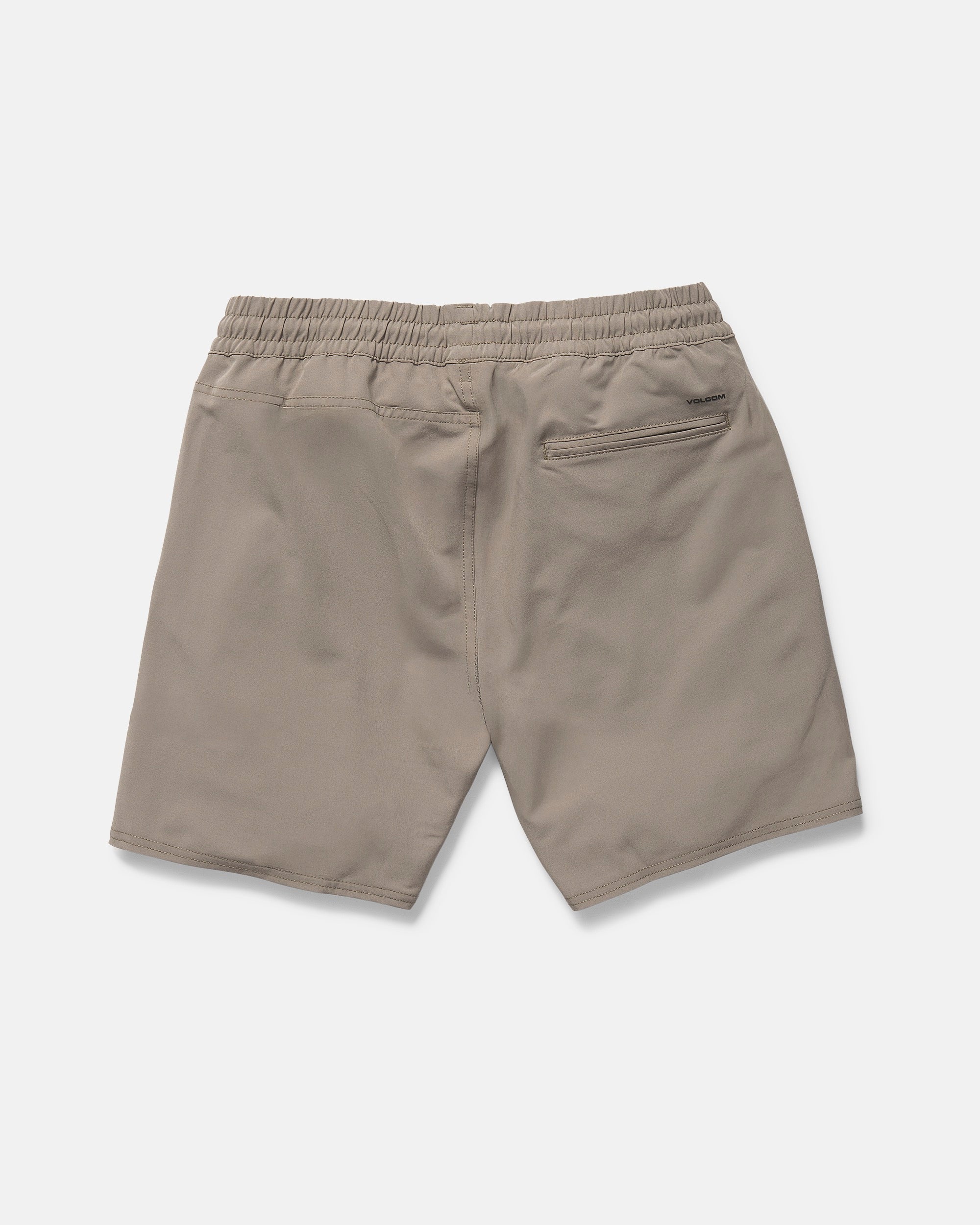 The Volcom Men's Nomoly Elastic Waist Shorts 18" in khaki are made from recycled polyester with 4-way stretch, featuring two side pockets and a zippered back pocket. Shown laid flat from the back on a white background.
