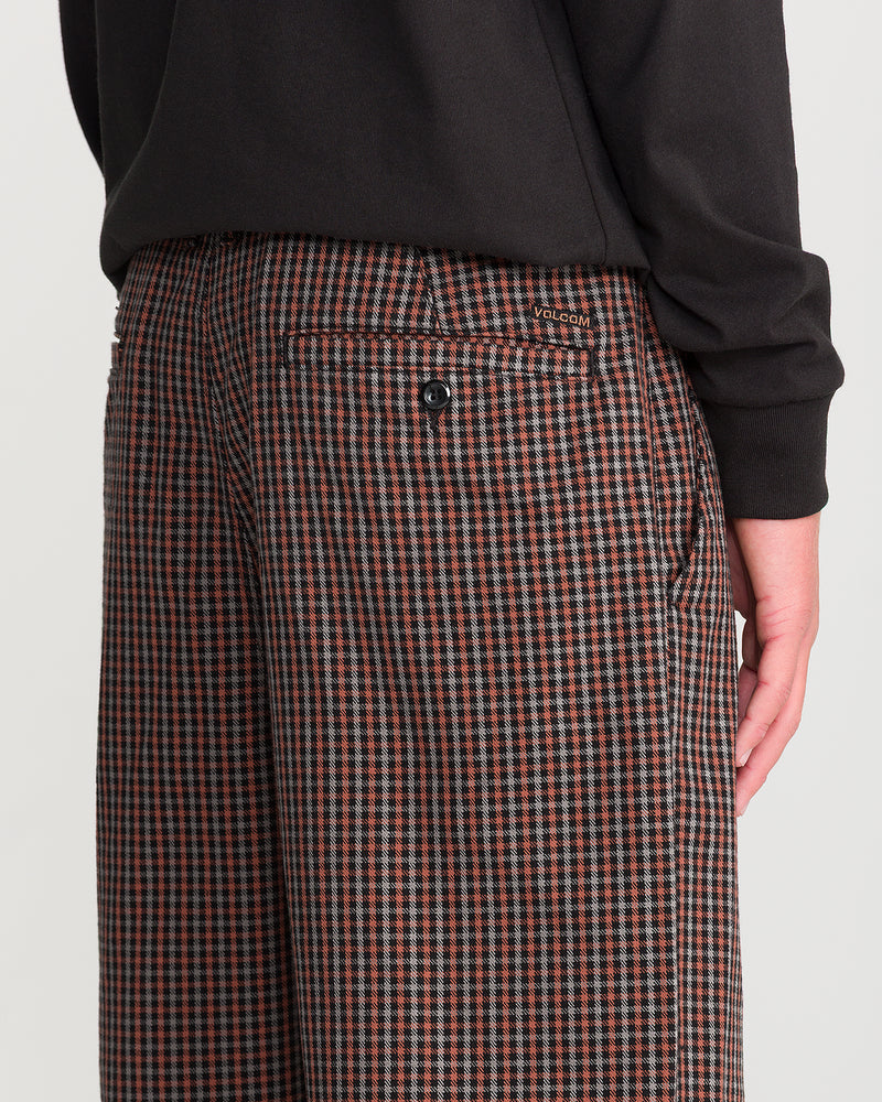Volcom Men’s Billow Plaid Pant: low-rise brown and black plaid twill trousers in a wide-leg cut with a single button-closure back pocket.