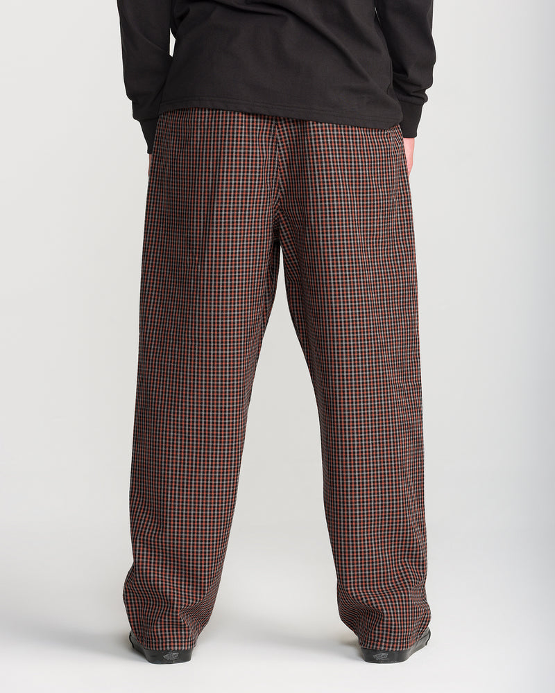 Back view of Volcom Men’s Billow Plaid Pant, a low-rise chino trouser in a brown and black box plaid twill.