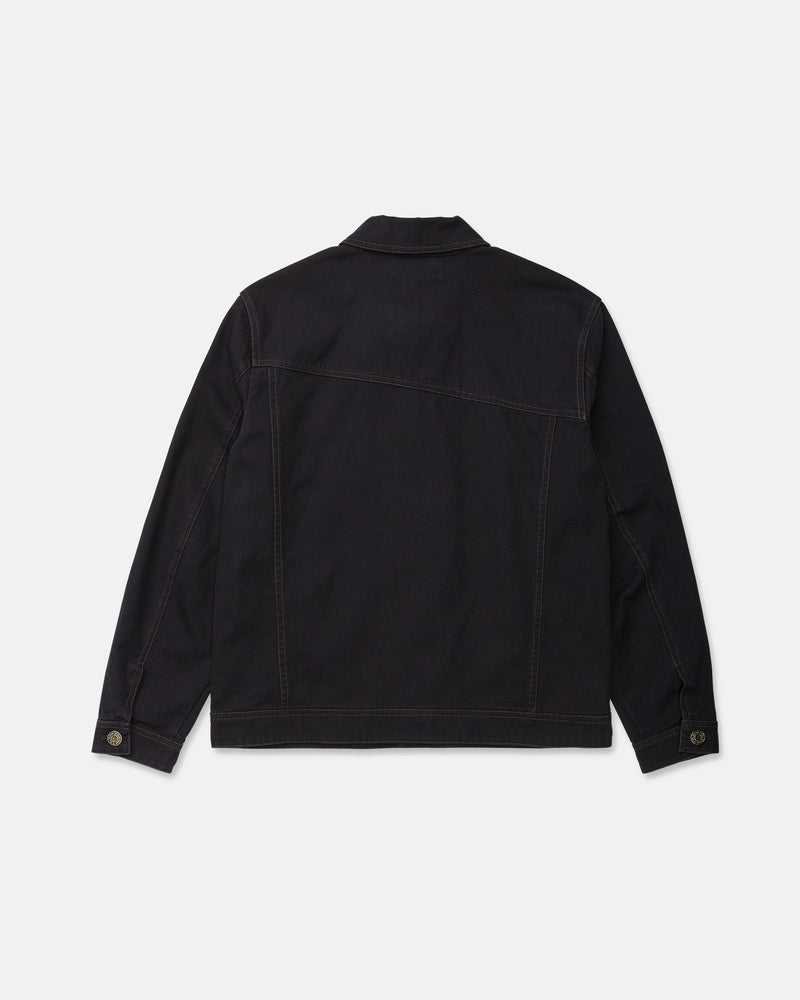 The Men's Slakers Jacket by Volcom is pictured from the back in black denim, showcasing long sleeves, brown stitching, a straight hem, and buttoned cuffs. Designed as a lightweight jacket, it is set against a plain white background.