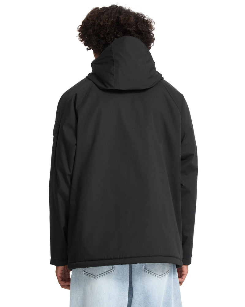 Back view of a person wearing a Volcom Men’s Stoke Stone II 10K Jacket and light-wash jeans.