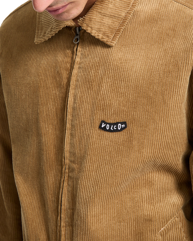 Volcom Men’s Kurtis Jacket in tan cotton corduroy, featuring a blouson silhouette and a logo patch on the chest.
