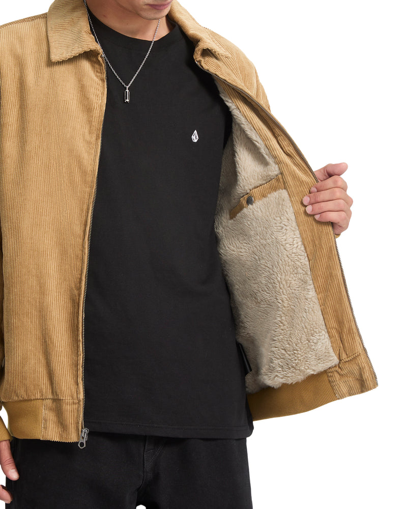 A tan cotton Volcom Men’s Kurtis Jacket with a faux-fur lining held open to show the interior.