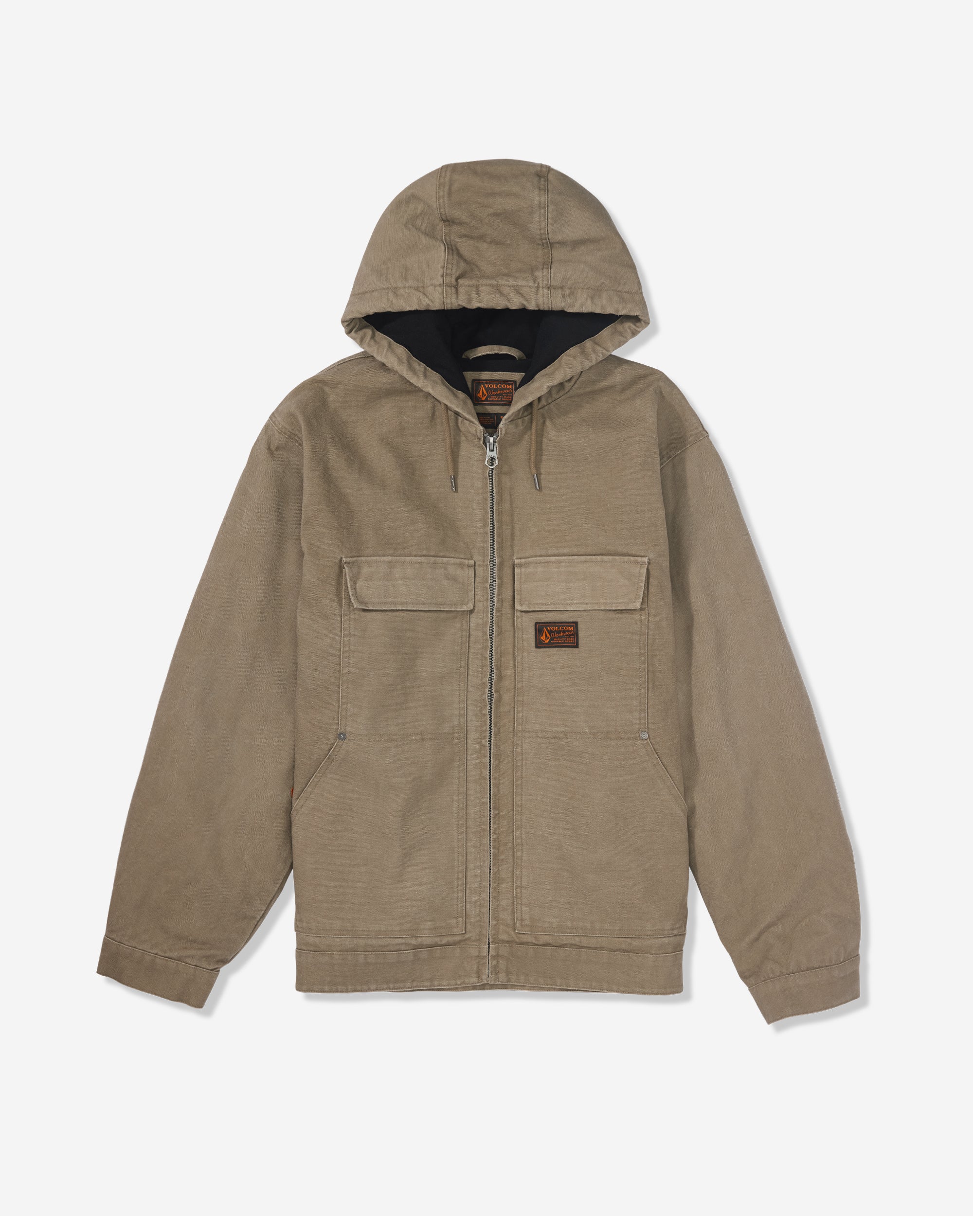 The Volcom Men's Freshdust Workwear Jacket in tan features a zip front, large flap hand and chest pockets, a small rectangular patch on the left chest, and long sleeves. Shown on a white background.