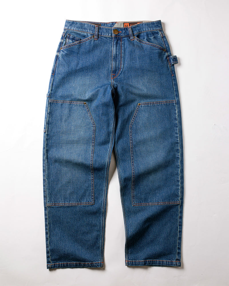 Volcom Men's Work Carpenter Denim jeans, featuring front patch pockets, a left-side hammer loop, and copper rivets, are displayed flat on a white background.